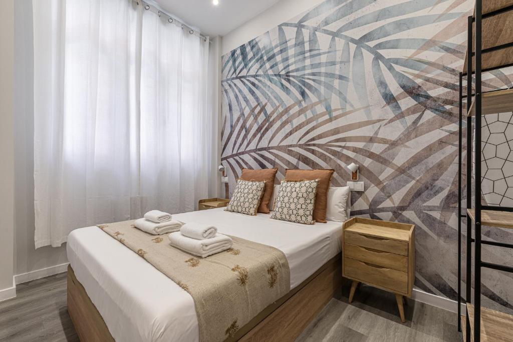 a bedroom with a bed with towels on it at BNBHolder Fresh Confort II in Madrid