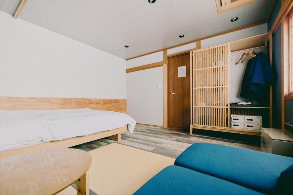 Postel nebo postele na pokoji v ubytování 結びの小宿 縁