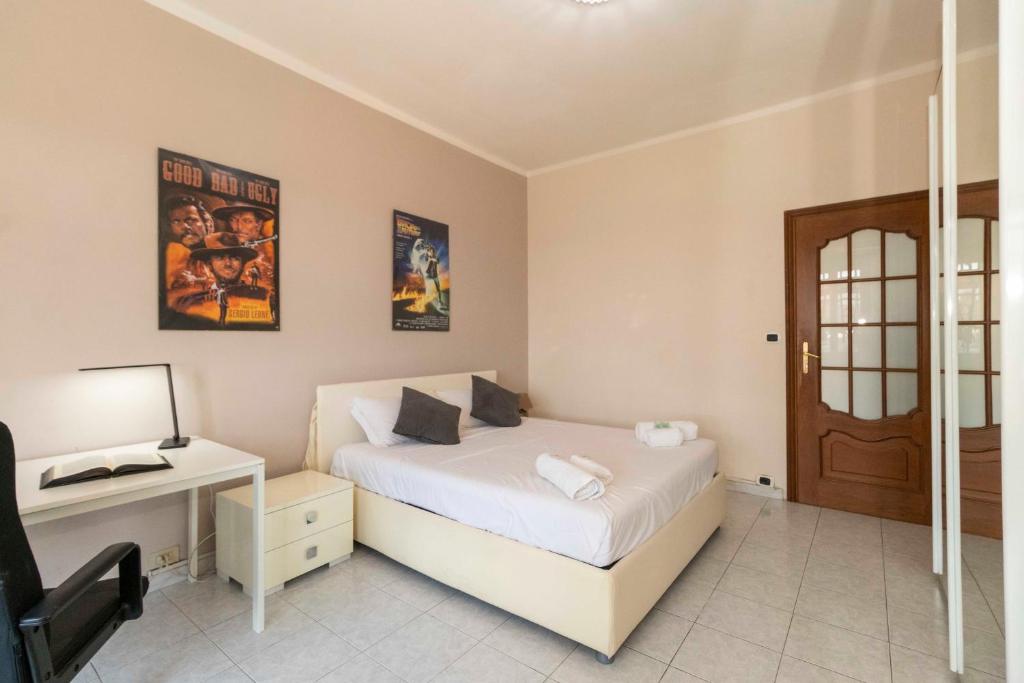 トリノにあるMM Bengasi Modern Apartmentのベッドルーム1室(ベッド1台、デスク、ドア付)