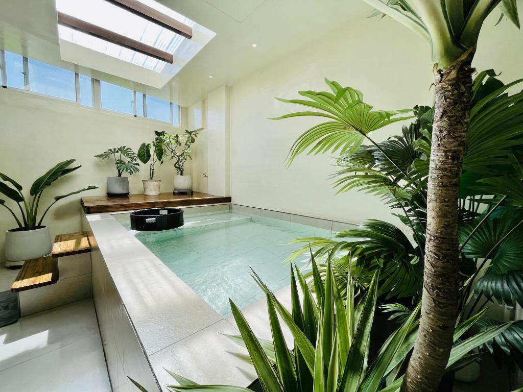 a swimming pool in a house with plants at Big Nose Inn in Hengchun South Gate