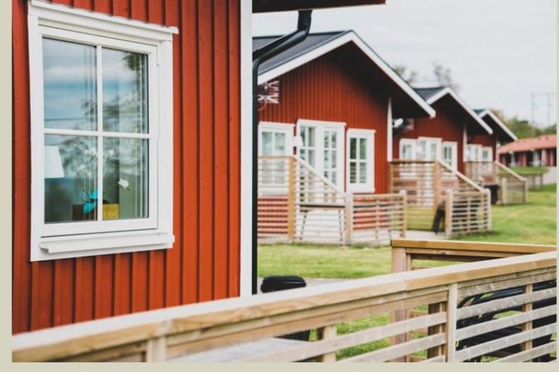 a red house with a window on the side of it at Mösseberg Camping in Falköping