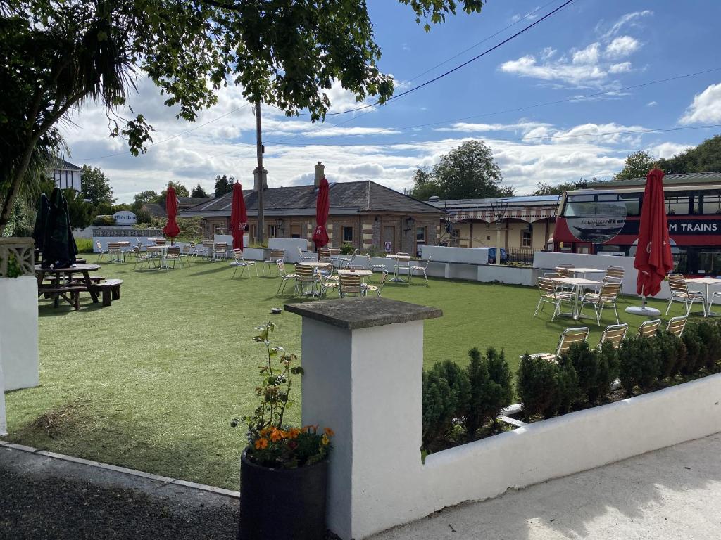 a park with tables and chairs and a bus at The Railway Inn in Brixham