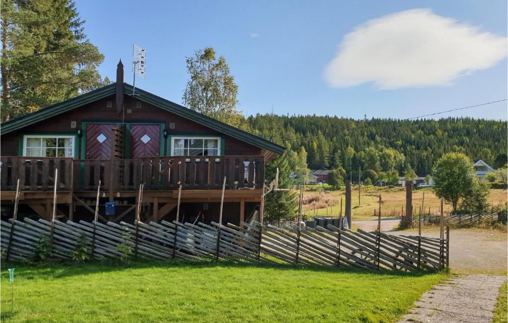 a log cabin with a fence in front of it at Amazing Apartment In Trysil With Kitchen in Trysil