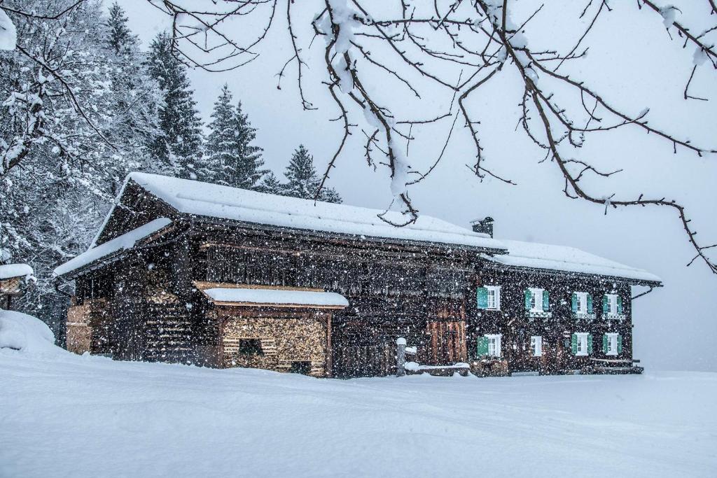 a building with snow on top of it at Ferienhaus Blendolma in Sankt Gallenkirch