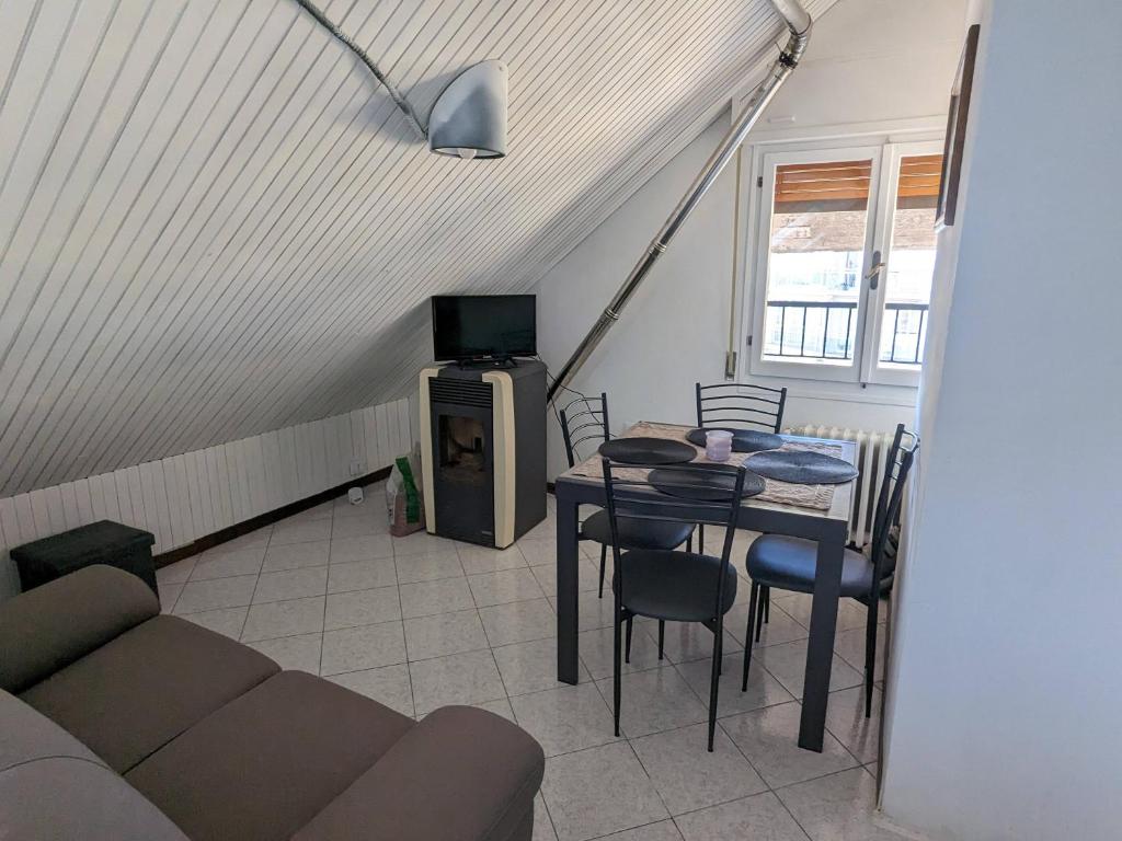 a living room with a table and a stove at Casa 2112 in Sestola