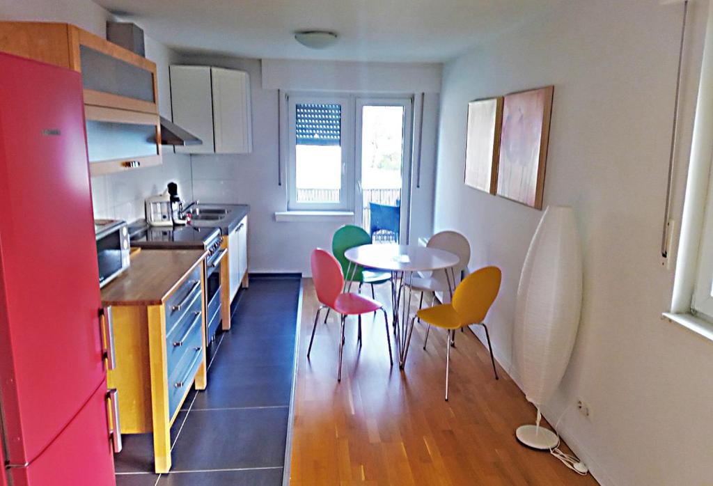 a kitchen with a table and four chairs in it at Sonnen-Apartment in Bad Honnef am Rhein