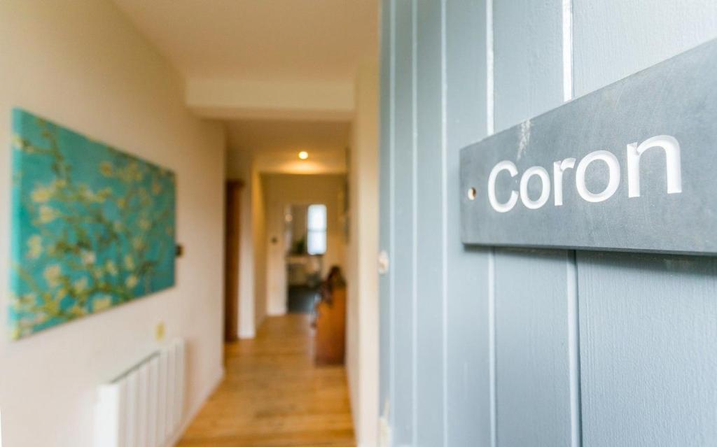 a sign that says corion on the side of a building at Coron in Aberffraw