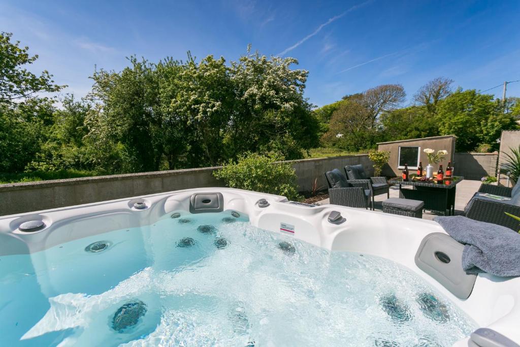 a hot tub in the backyard of a house at Cil Haul in Llanfaelog