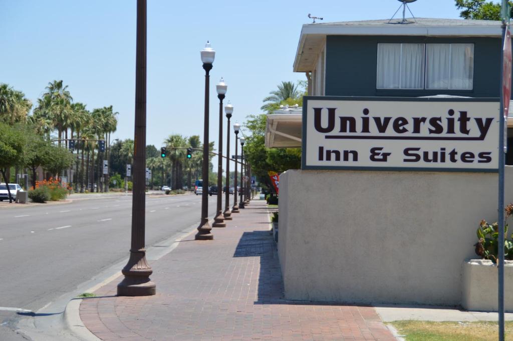 ein Schild für ein Gasthaus und Suiten an einer Straße in der Unterkunft University Inn ASU/Tempe in Tempe