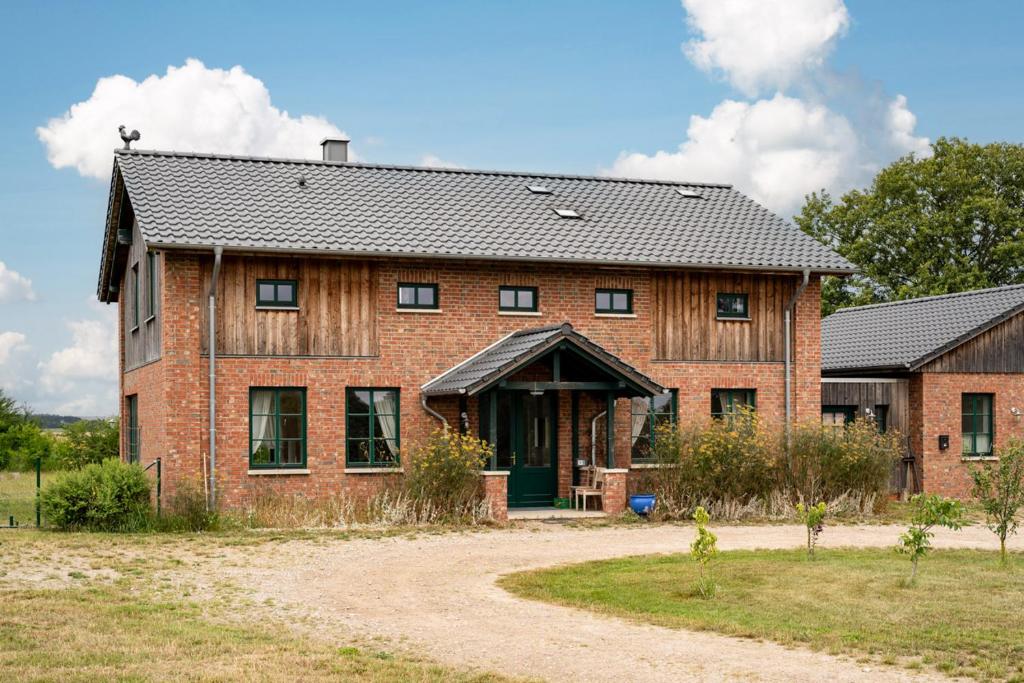 a large brick house with a black roof at Ferienhaus Landurlaub mit Kamin in Schwarz