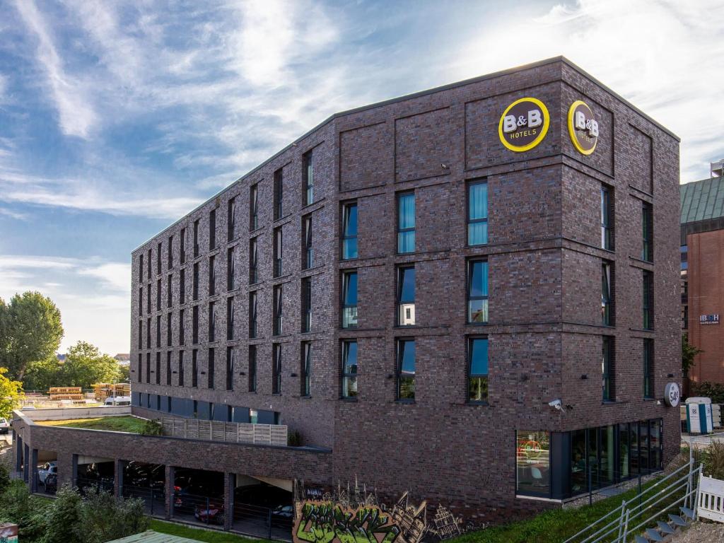 a large brick building with a clock on it at B&B Hotel Lübeck in Lübeck