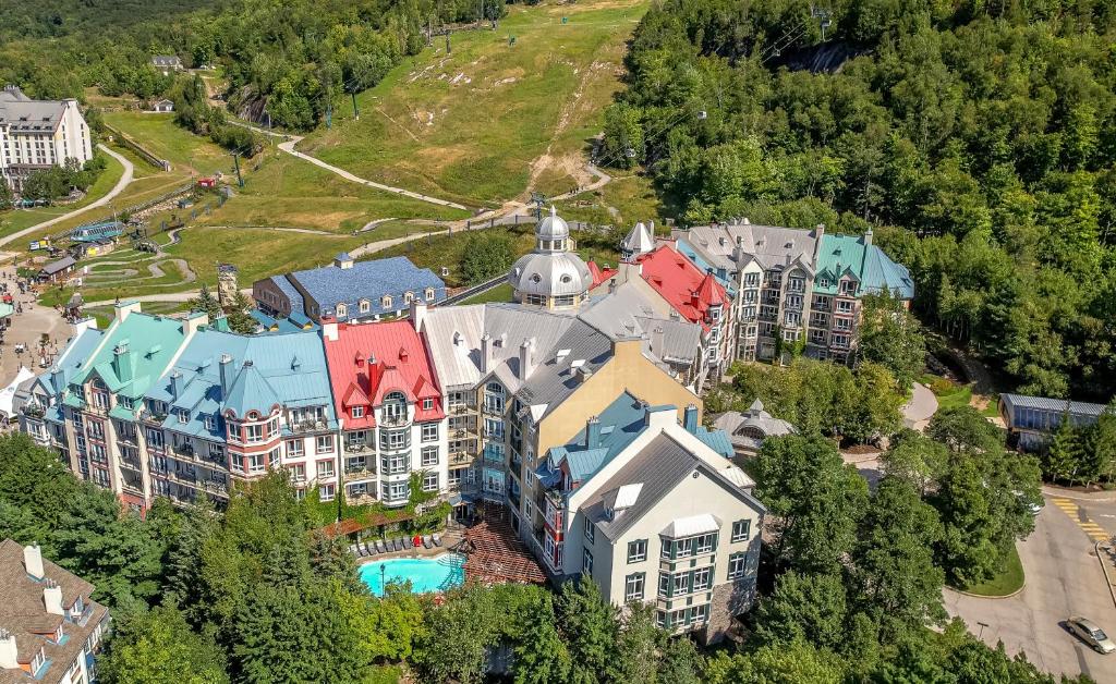 an aerial view of a resort building with a pool at Sommet Des Neiges in Mont-Tremblant