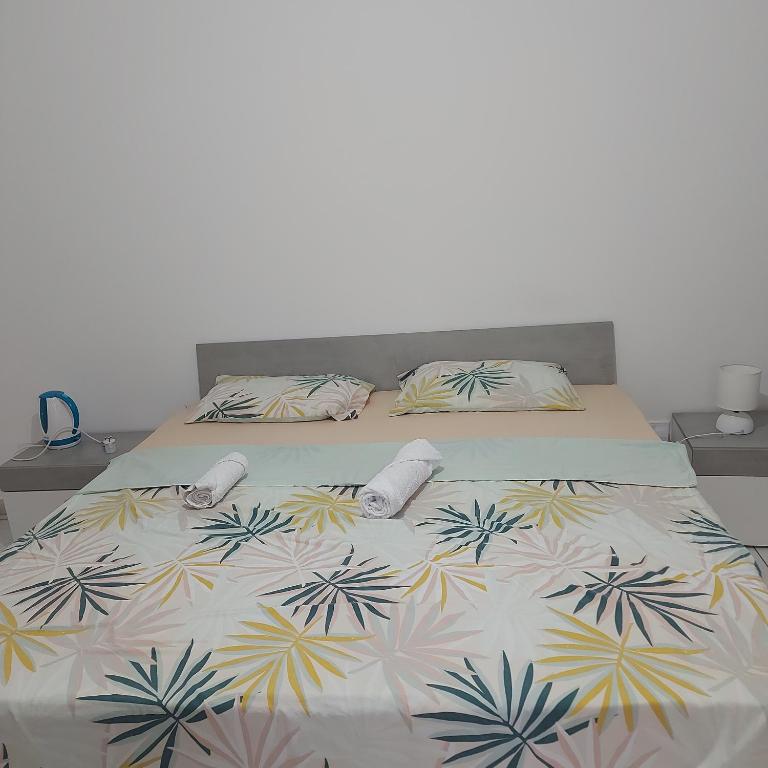 a bed with two slippers and a blanket on it at CASA GRIMA - private double room in Birkirkara