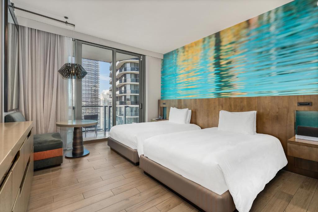 a hotel room with two beds and a television at EAST Miami in Miami