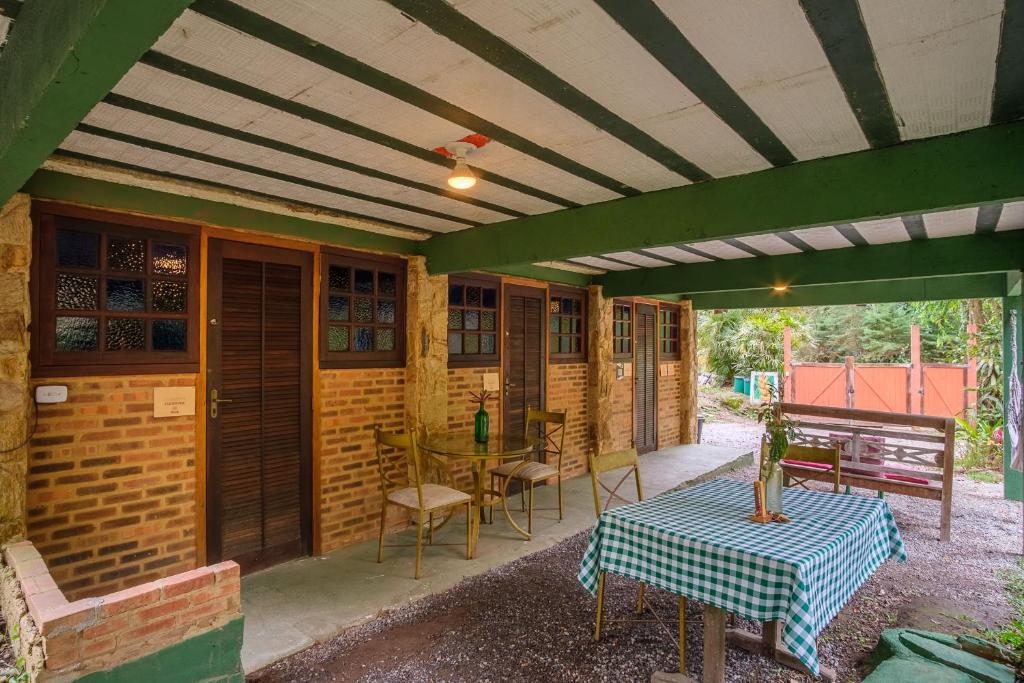 a patio with a table and chairs on it at Auá Hostel in Petrópolis