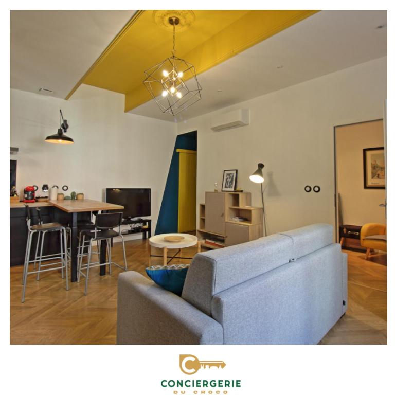 un salon avec un canapé et une table dans l'établissement Le Sensas - Climatisation et Centre, à Nîmes