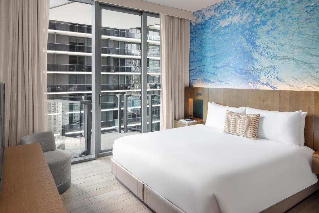 a bedroom with a white bed and a large window at EAST Miami in Miami