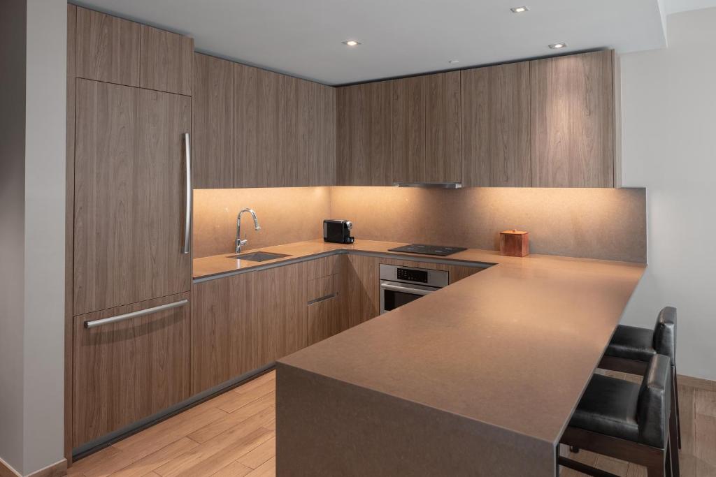 a kitchen with wooden cabinets and a counter top at EAST Miami in Miami