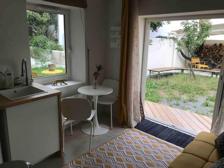 a kitchen with a table and a door to a patio at Maison du Saleys in Salies-de-Béarn