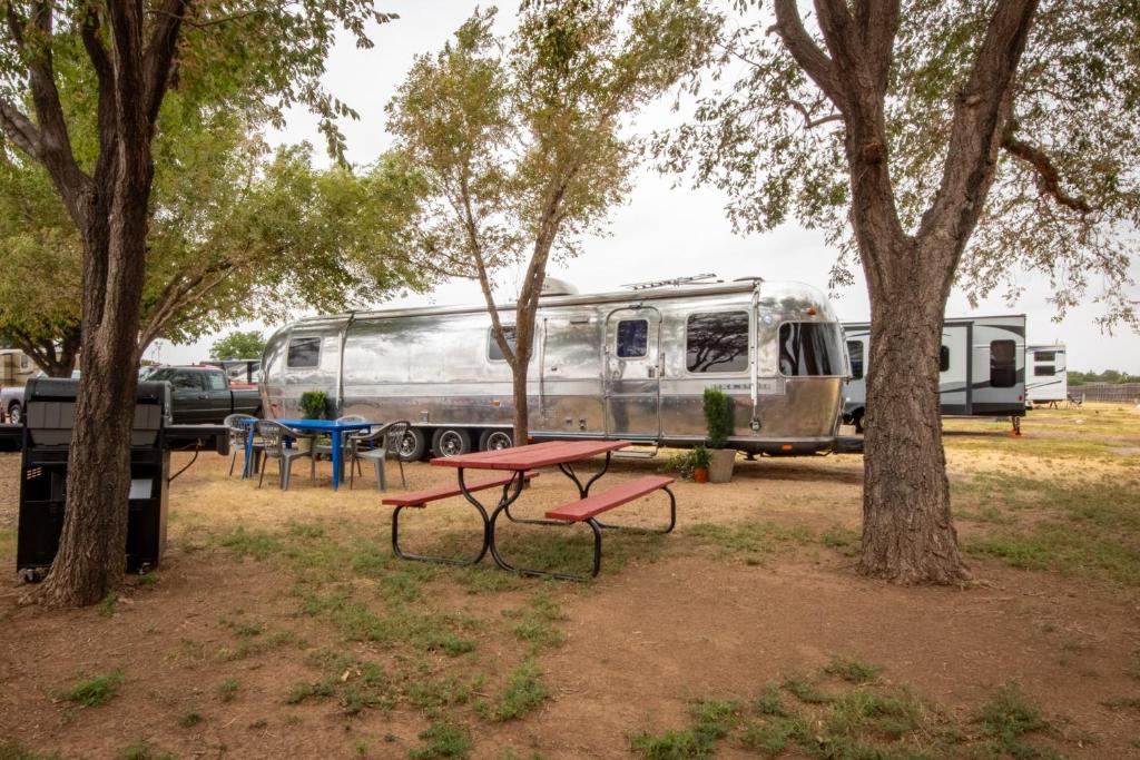 a park with a picnic table and a trailer at Big Texan Airstream in Amarillo