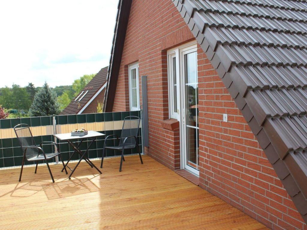 a balcony with a table and chairs on a brick building at Ferienwohnung-Sonnenterrasse in Malchow