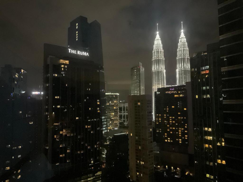 a view of a city at night with the burj building at 8 Kia Peng Central Suites in Kuala Lumpur