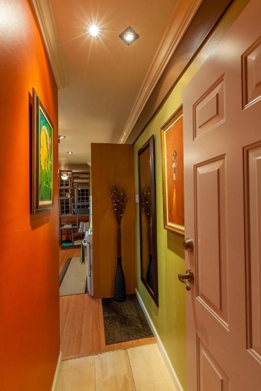 a hallway with an orange and green wall at Choose To Be Happy at Seymour # 9 and #16 - Studio Apartments in Kingston