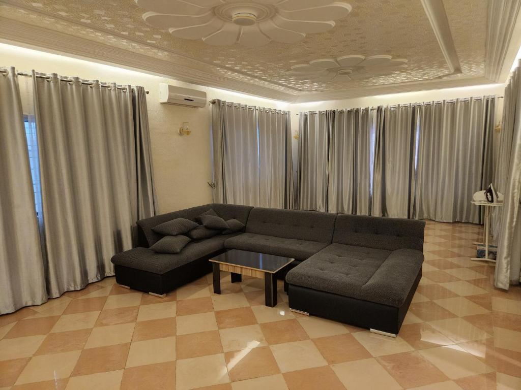 a living room with a couch and a table at Romo Cocotier in Cotonou