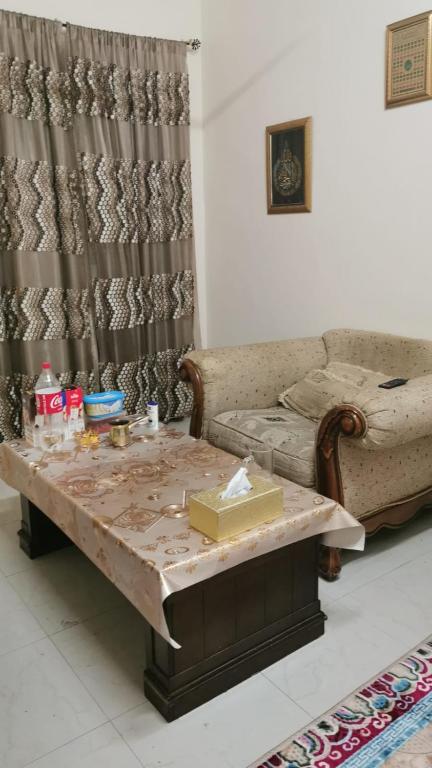 a living room with a couch and a coffee table at An appartment for rent in Ajman Alreqah Building in Ajman 