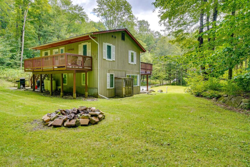 a house with a fire pit in the yard at Cozy Killington Retreat about 5 Mi to Ski Resort in Killington