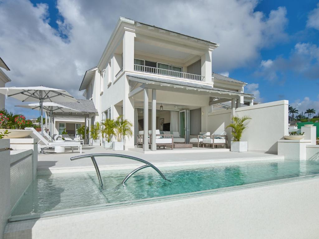 an exterior view of a villa with a swimming pool at Apes Hill Barbados Golf and Resort Community in Saint James