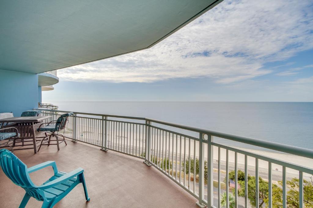 a balcony with chairs and a table and the ocean at Beachfront Gulfport Vacation Rental with Balcony! in Gulfport