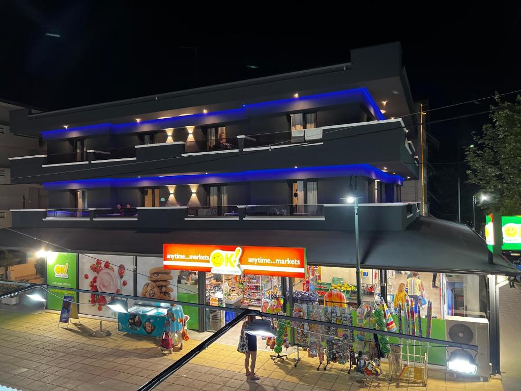 a building at night with people standing outside of it at Blue Sea Boutique Apartments in Olympic Beach