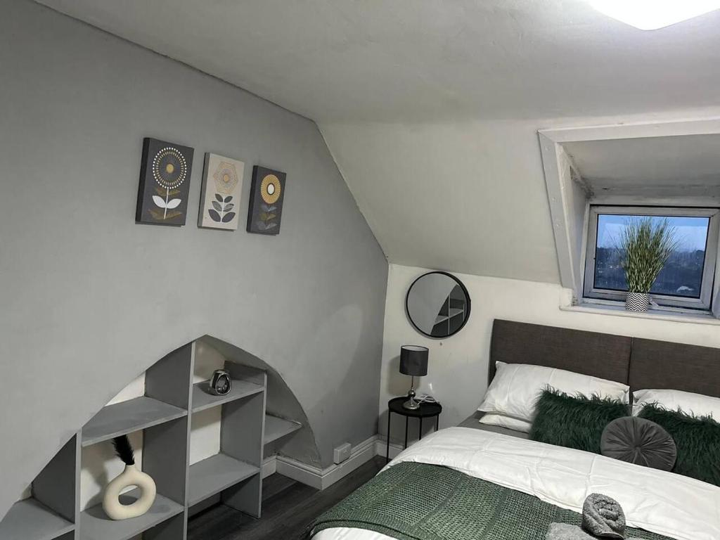 a white bedroom with a bed and a window at Stunning studio Apartment in Newport in Newport