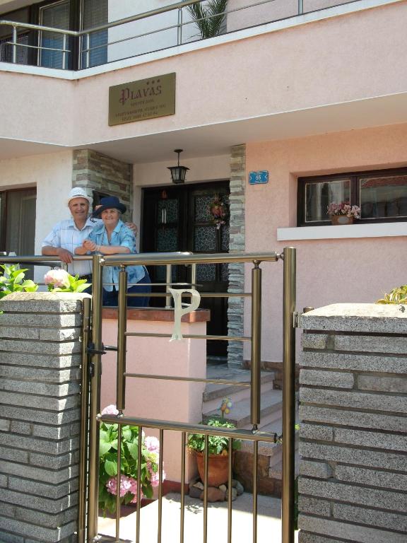 two people standing in front of a building at Guest House Plavas in Sozopol