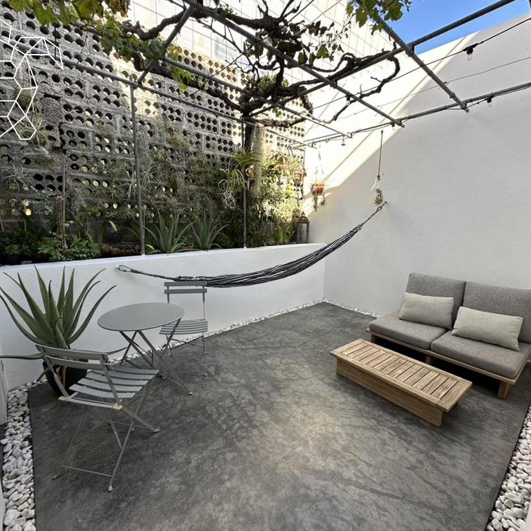 a patio with a hammock and a table and chairs at Caretta Caretta's House in Los Llanos de Aridane