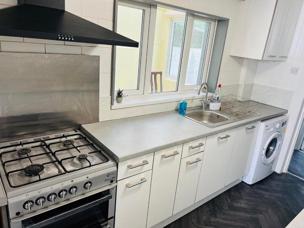 a kitchen with a stove and a sink at Great Accommodation in Medway in Gillingham