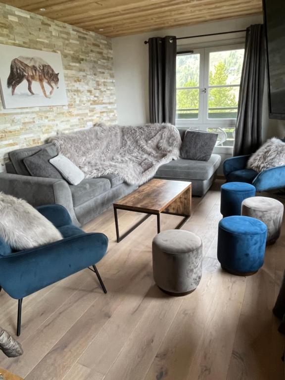 a living room with a couch and chairs and a table at Arc 1950 Ap 171 Résidence les Sources de Marie in Bourg-Saint-Maurice