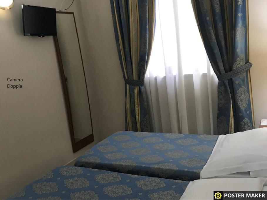 Postel nebo postele na pokoji v ubytování Hotel Rigolfo