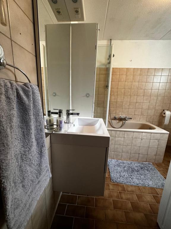 a bathroom with a sink and a bath tub at Room in Oss in Oss