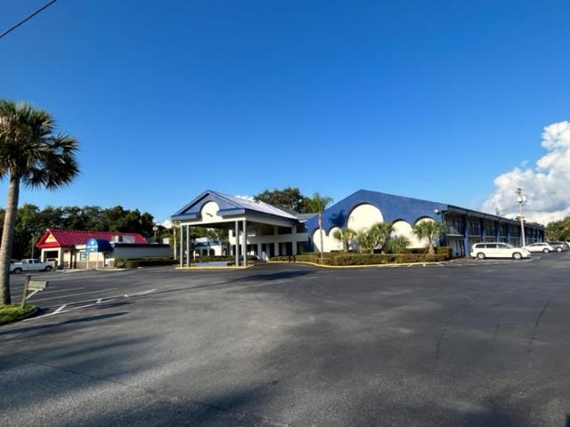 a parking lot in front of a large building at Days Inn by Wyndham Crystal River in Crystal River