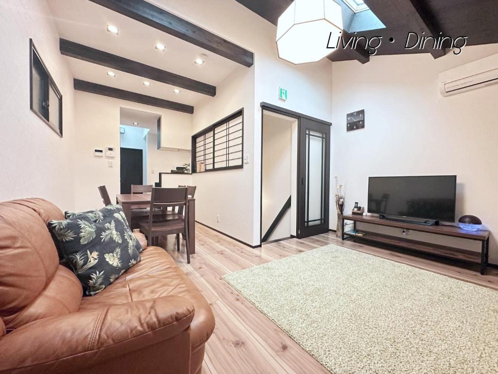 a living room with a couch and a flat screen tv at WeeklyHouse Biwako Otsu - Vacation STAY 62243v in Otsu