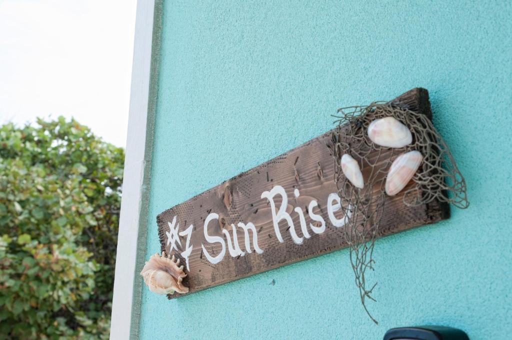 a sign that says my sun rise on a wall at The Sunrise at Cottages in Sand Bluff