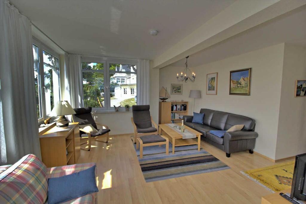 a living room with a couch and a table at Villa Seeblick Apartment 307 in Sassnitz