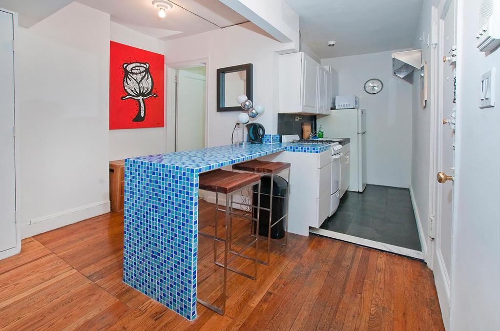 a kitchen with a blue counter top in a room at Midtown East Next to Times Square in New York