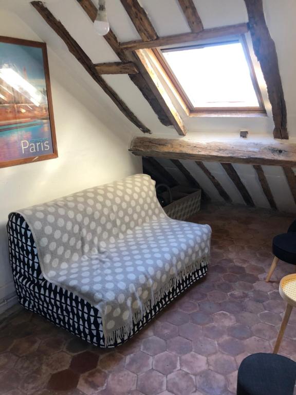 - un salon avec un banc et une fenêtre dans l'établissement STUDIO sous les toits de PARIS GRANDS BOULEVARDS, à Paris