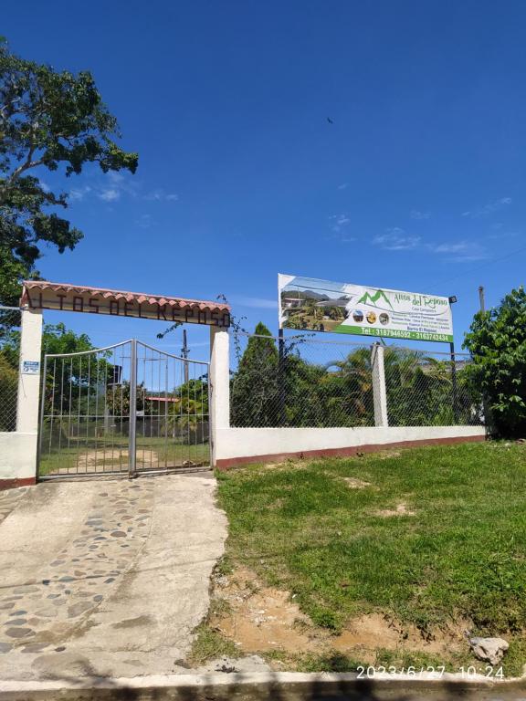 a gate with a view of the ocean behind it at Altos del Reposo Casa Campestre in Pueblo Bello