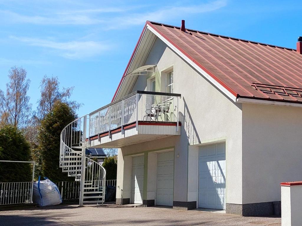 a house with a staircase on the side of it at Penthouse with a balcony in Hyvinkää