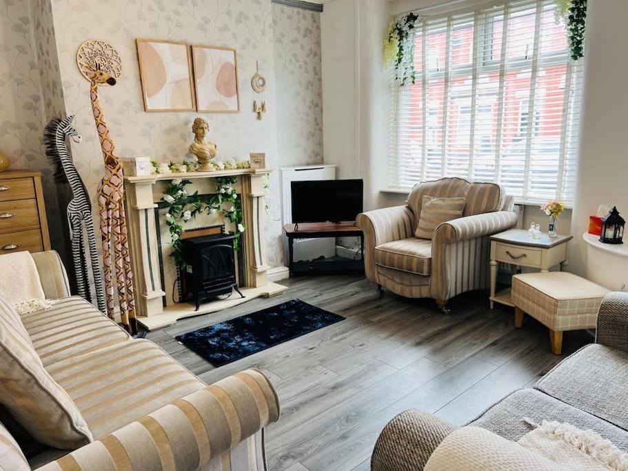 a living room with a couch and a fireplace at The First-central Wigan 8 guests in Wigan