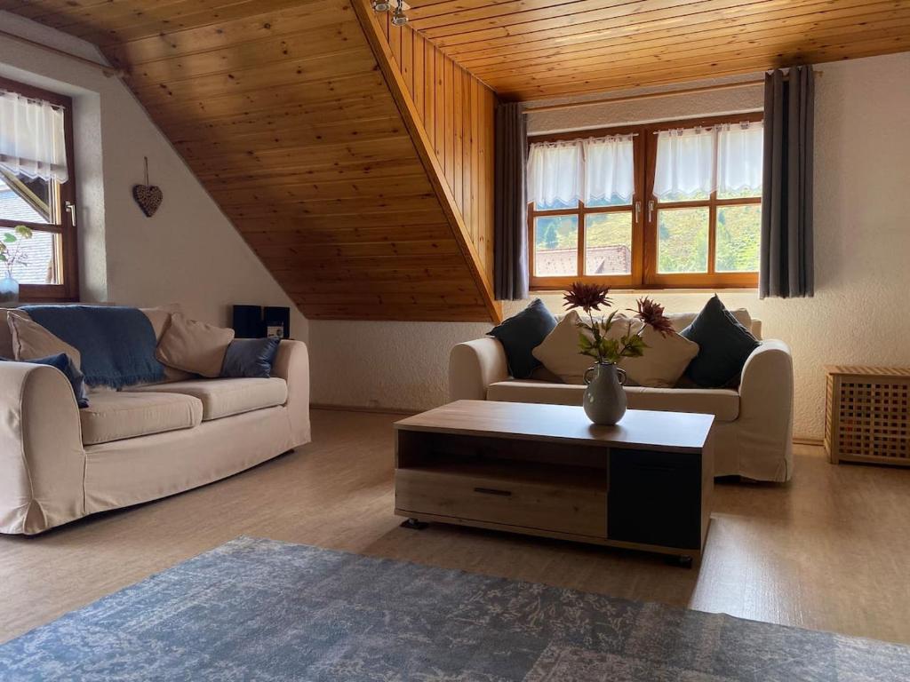 a living room with two couches and a coffee table at Forest Apartment Menzenschwand in St. Blasien